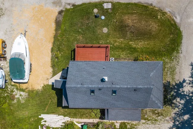 a roof deck with table and chairs potted plants