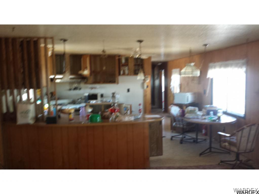 4110 Concho Road Golden Valley, AZ 86413 - Photo 7 of 10 a kitchen with a dining table and chairs