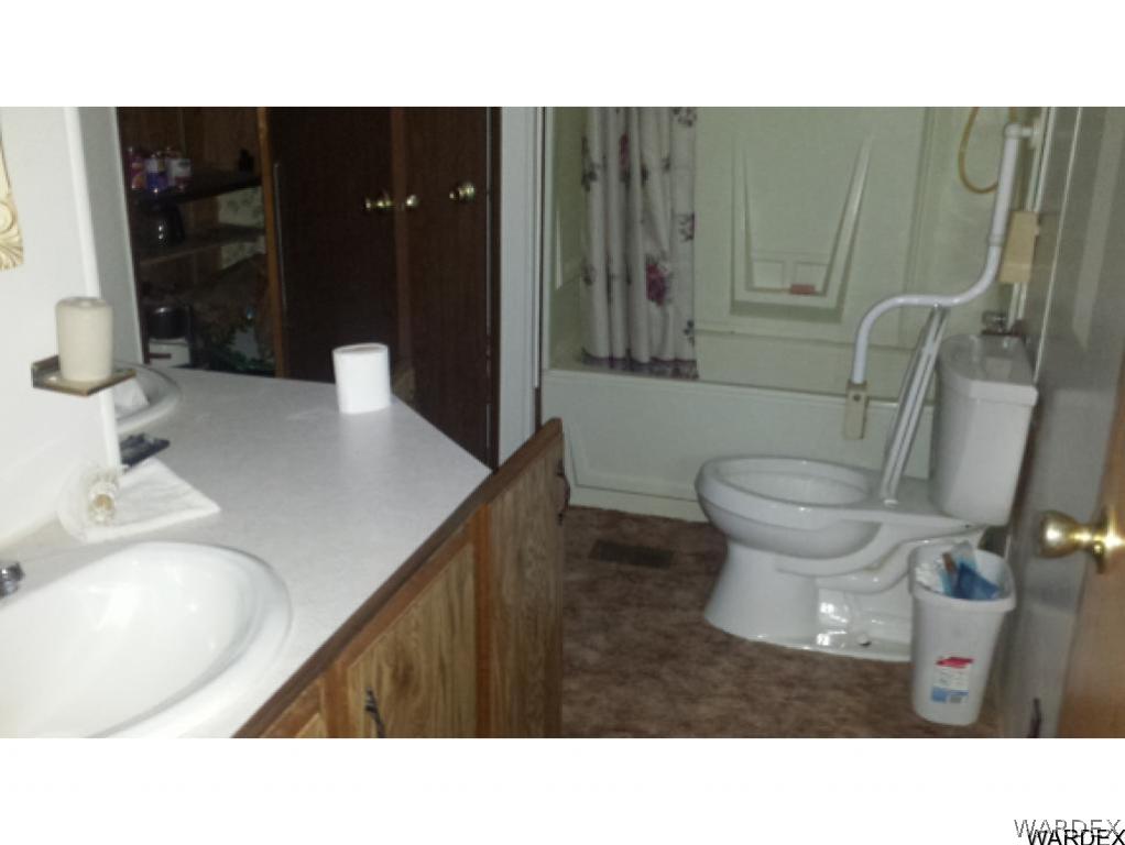 4110 Concho Road Golden Valley, AZ 86413 - Photo 8 of 10 a bathroom with a sink toilet and shower