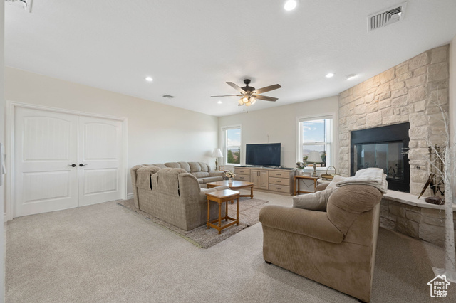 230 Boulder Way Leeds, UT 84746 - Photo 15 of 72 Main Family Room area with a fireplace, light colored carpet, recessed lighting, ceiling fan, floor to ceiling wood burning stone fireplace and built in cabinet. Double doors are to the 5th bedroom / exercise or game room.