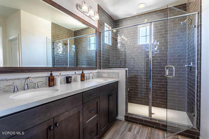 239 Stonegate Road Camarillo, CA 93010 - Photo 17 of 25 a bathroom with a double vanity sink mirror and shower
