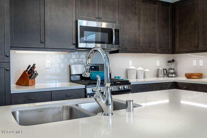 239 Stonegate Road Camarillo, CA 93010 - Photo 5 of 25 a kitchen with stainless steel appliances wooden cabinets a sink and a stove