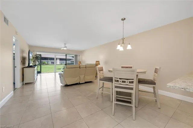 a view of a kitchen with furniture and an empty room