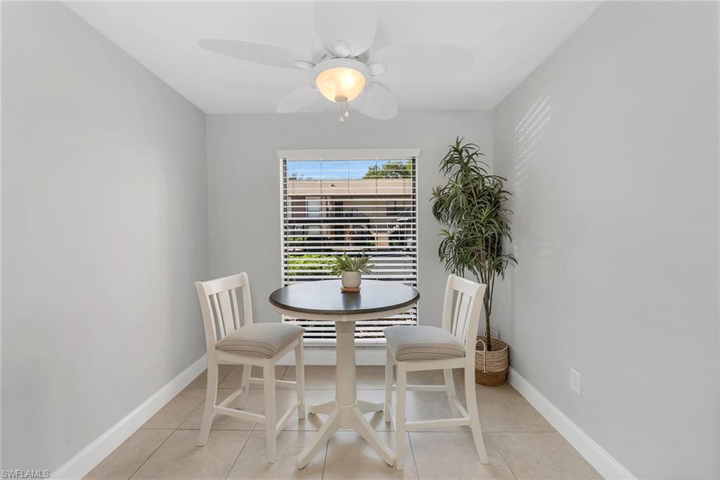236 Pebble Beach Circle, Unit A102 Naples, FL 34113 - Photo 20 of 40 a dining room with furniture and window
