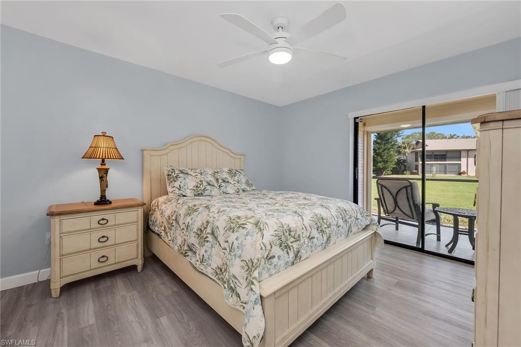 236 Pebble Beach Circle, Unit A102 Naples, FL 34113 - Photo 21 of 40 a bed sitting in a bedroom next to a window