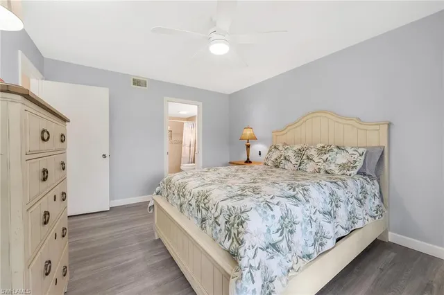 a large bed sitting in a bedroom next to a window and a dresser