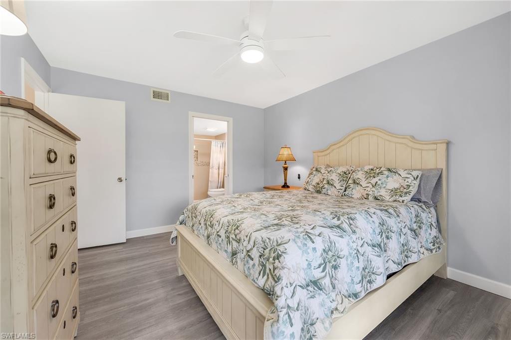 236 Pebble Beach Circle, Unit A102 Naples, FL 34113 - Photo 22 of 40 a large bed sitting in a bedroom next to a window and a dresser