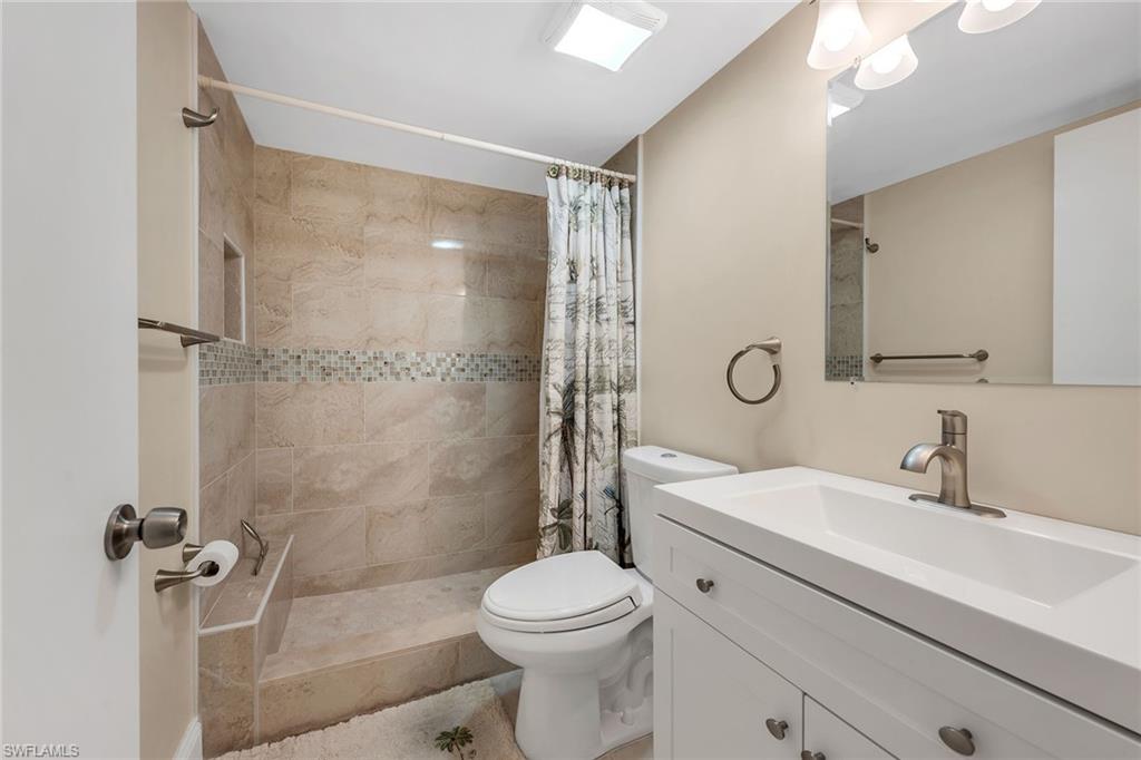 236 Pebble Beach Circle, Unit A102 Naples, FL 34113 - Photo 26 of 40 a bathroom with a sink toilet and shower
