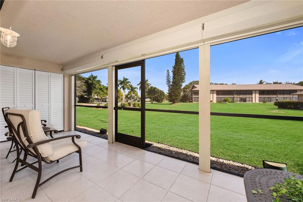 236 Pebble Beach Circle, Unit A102 Naples, FL 34113 - Photo 28 of 40 a view of a two chairs and a big room