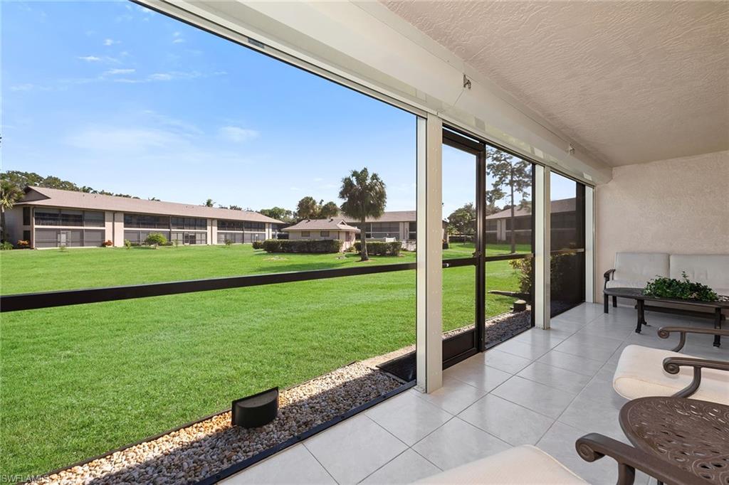 236 Pebble Beach Circle, Unit A102 Naples, FL 34113 - Photo 30 of 40 a view of an house with backyard porch and furniture