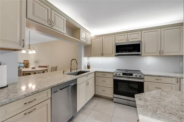 a kitchen with a sink stove and microwave