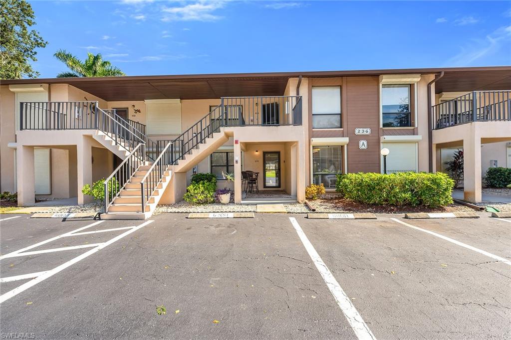 236 Pebble Beach Circle, Unit A102 Naples, FL 34113 - Photo 35 of 40 a front view of a building with a road