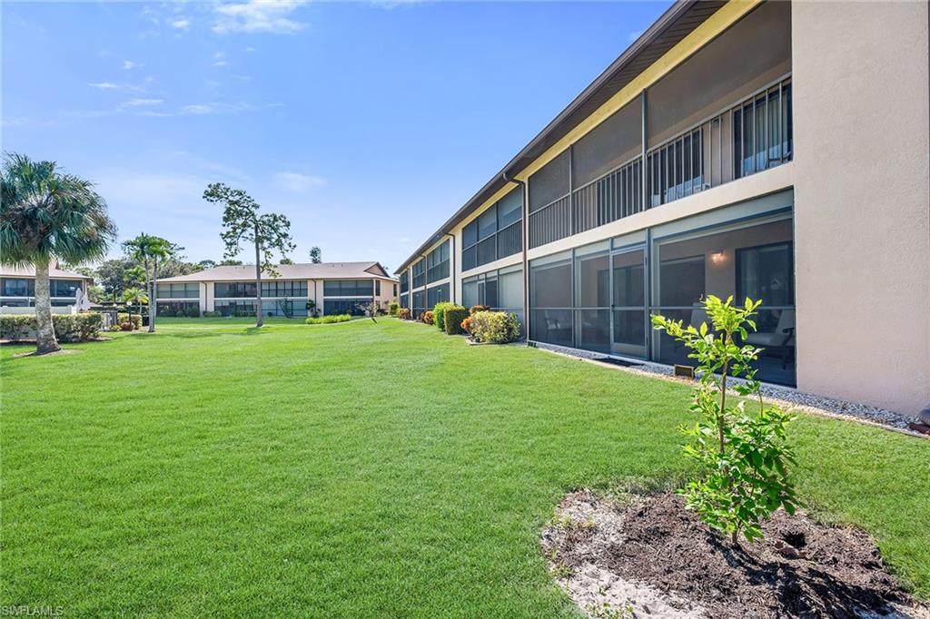 236 Pebble Beach Circle, Unit A102 Naples, FL 34113 - Photo 37 of 40 a house view with a garden space