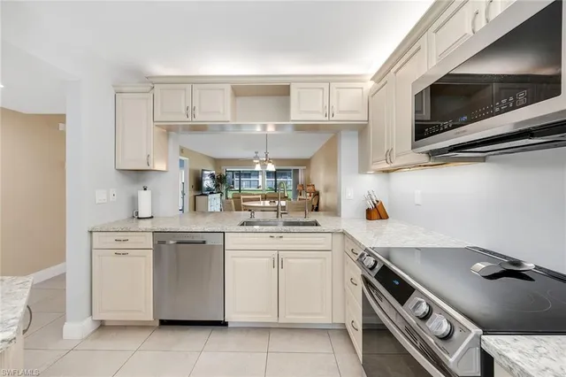 a kitchen with a sink appliances and cabinets