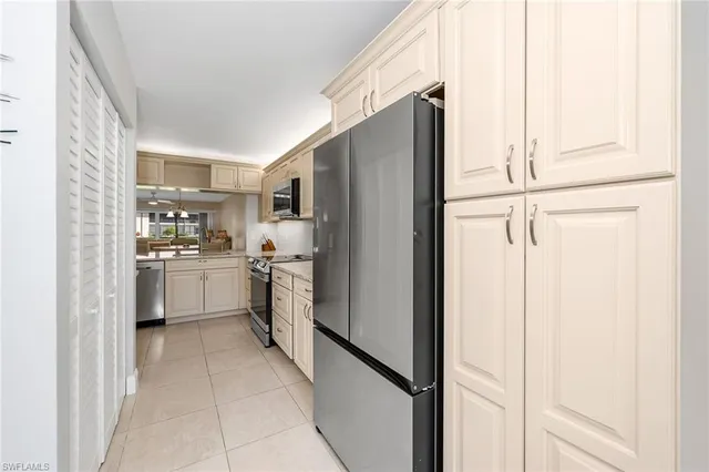 a kitchen with white cabinets and white appliances