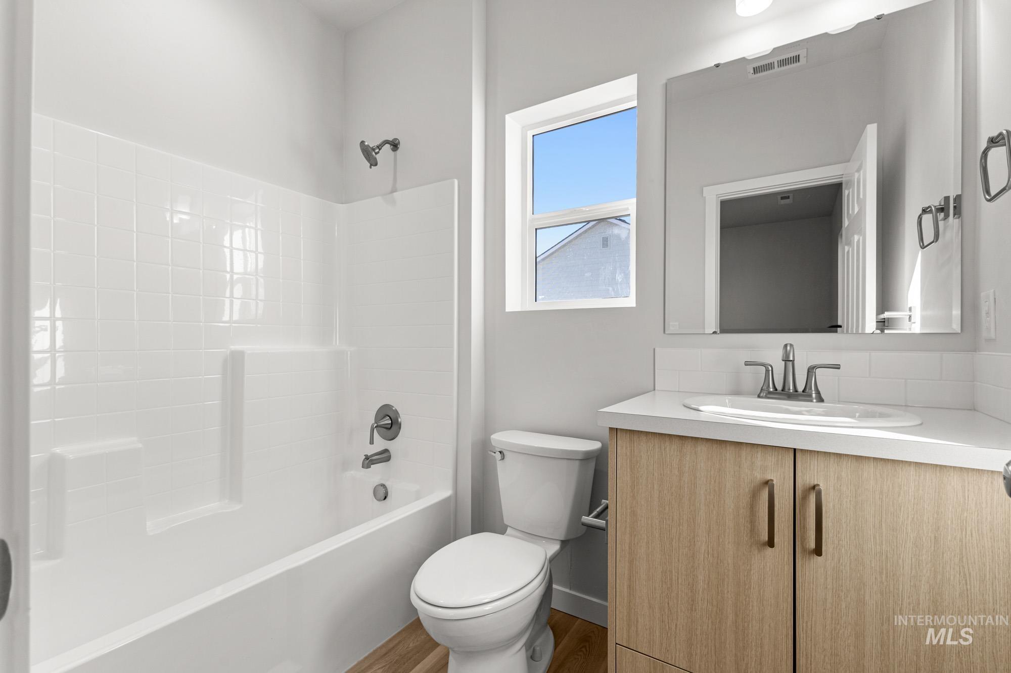 13708 Judson Street Caldwell, ID 83607 - Photo 23 of 29 Bathroom with vanity, shower / tub combination, and wood finished floors