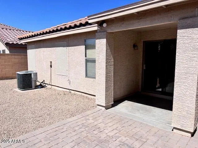 a narrow alley with a white house