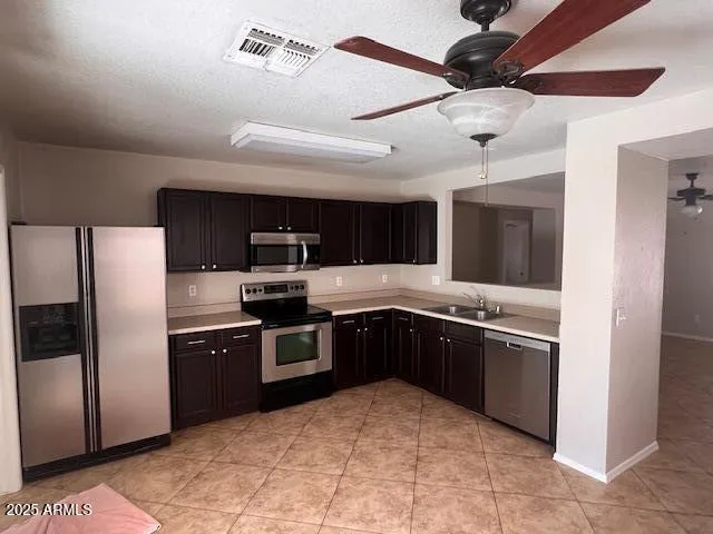 a large kitchen with cabinets and stainless steel appliances