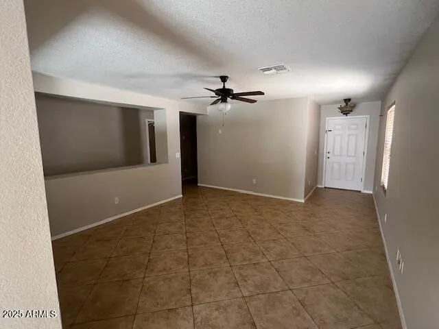 a view of a hallway with a ceiling fan