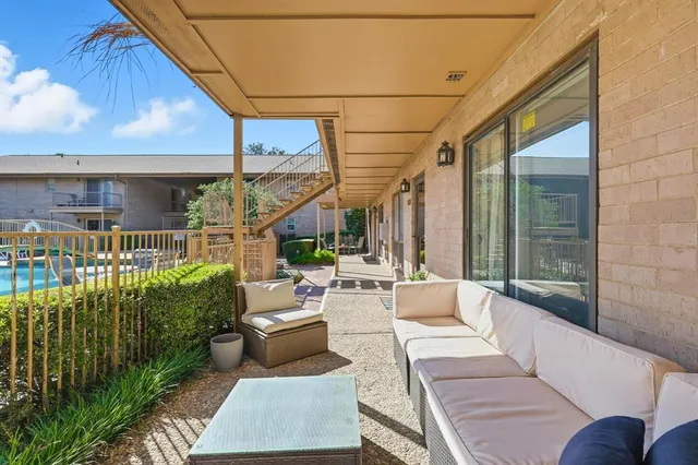 a balcony with furniture and a potted plant