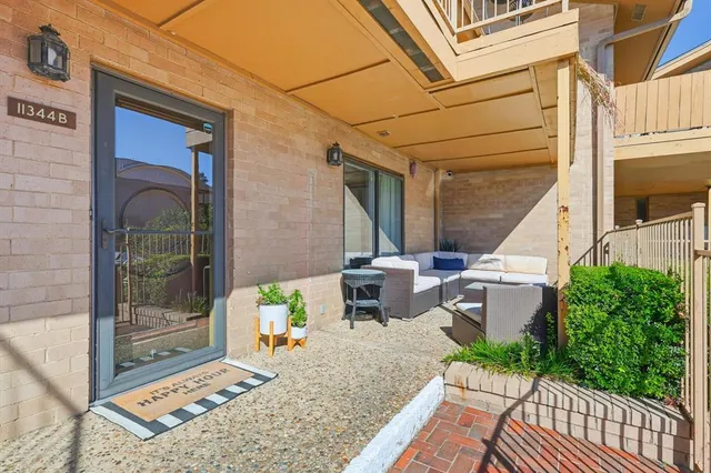 a view of a patio with table and chairs and potted plants