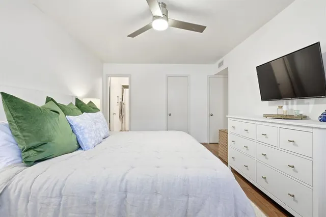 a bedroom with a large bed and a flat screen tv