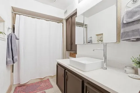 a bathroom with a sink and a mirror