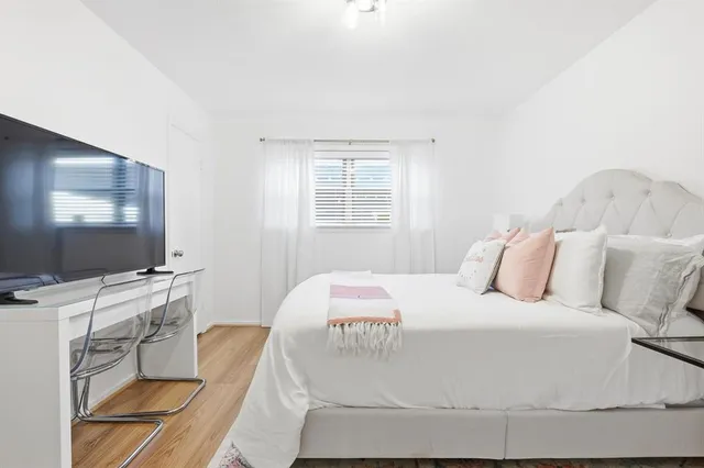 a bedroom with a bed and a flat screen tv