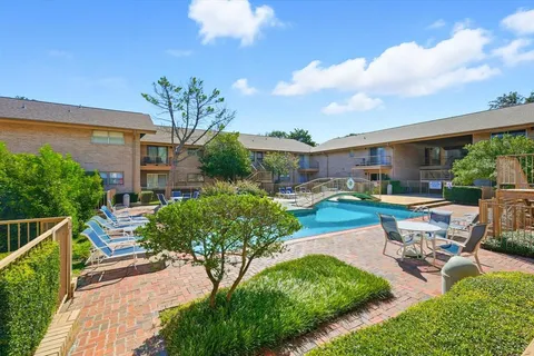 a view of a house with swimming pool and sitting area