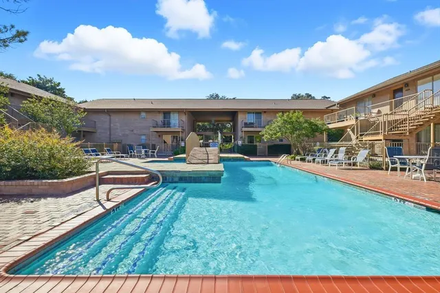a view of a house with swimming pool and sitting area