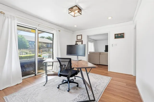 a workspace with wooden floor and a window