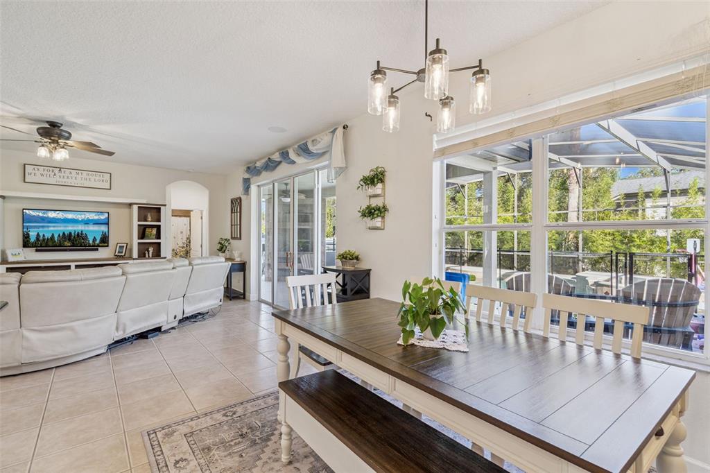 1471 Wescott Loop Winter Springs, FL 32708 - Photo 13 of 57 a dining room with furniture a chandelier and wooden floor