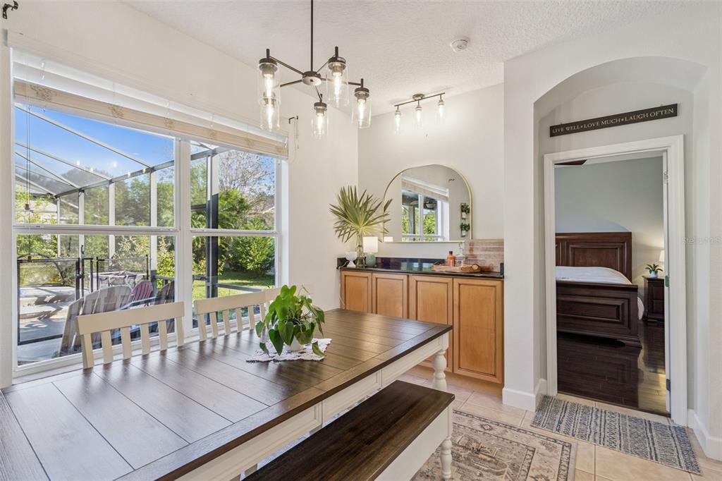 1471 Wescott Loop Winter Springs, FL 32708 - Photo 15 of 57 a view of a dining room with furniture a chandelier and wooden floor