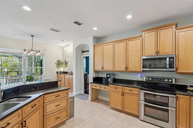 a kitchen with refrigerator and cabinets