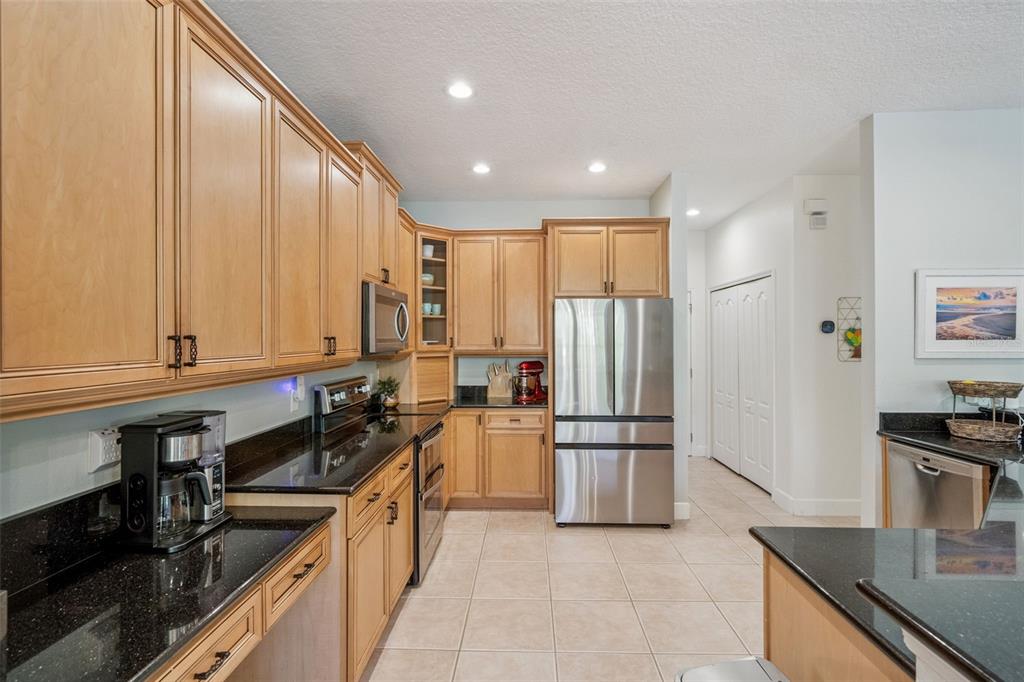 1471 Wescott Loop Winter Springs, FL 32708 - Photo 19 of 57 a kitchen with refrigerator and cabinets