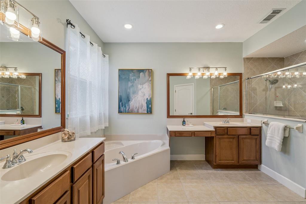1471 Wescott Loop Winter Springs, FL 32708 - Photo 23 of 57 a bathroom with a tub a sink double vanity and a mirror