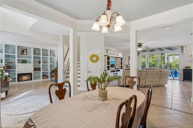 a view of a dining room with furniture and chandelier