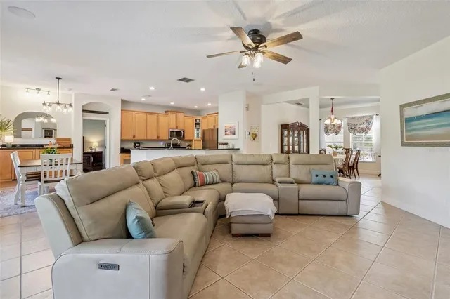 a living room with furniture and a view of kitchen