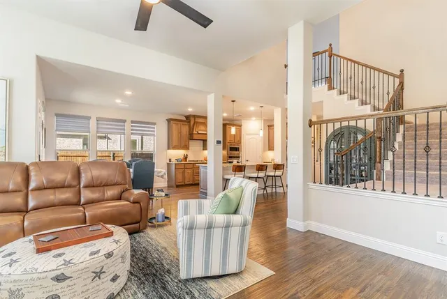 a living room with furniture and a floor to ceiling window