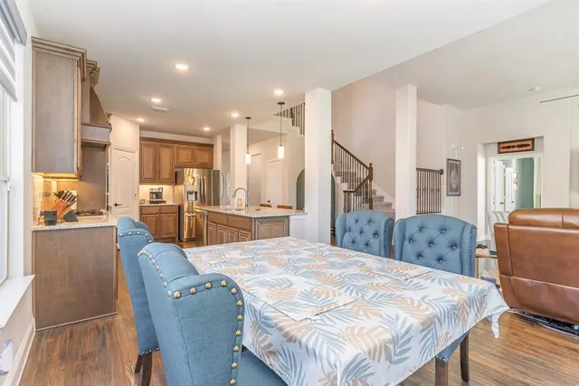 a large bedroom with a large bed and a view of kitchen