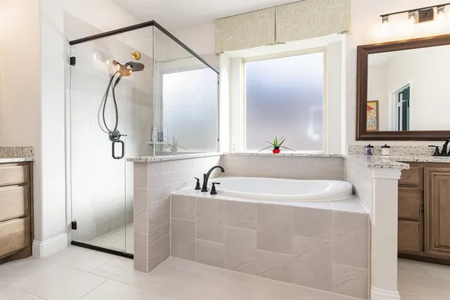a bathroom with a double vanity sink mirror double and bathtub
