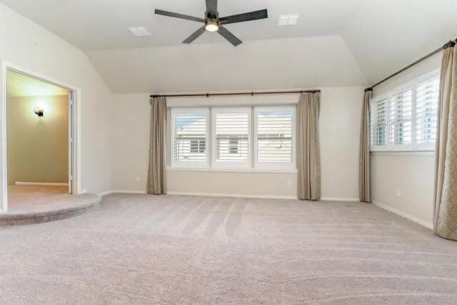 an empty room with closet and windows