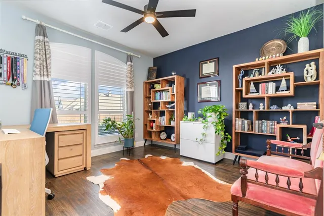 a living room with furniture and a bookshelf