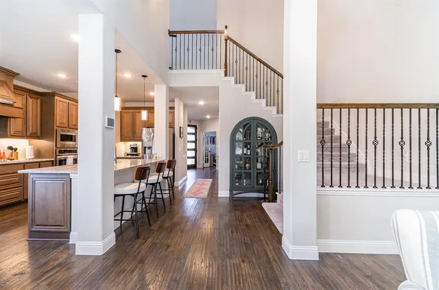 a view of a kitchen with furniture and wooden floor