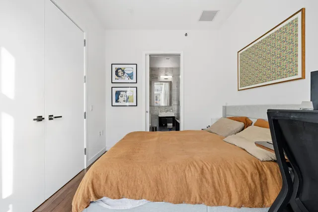 a bedroom with a large bed and a window