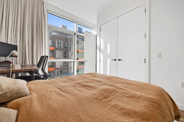 a bedroom with a bed and painting on the wall