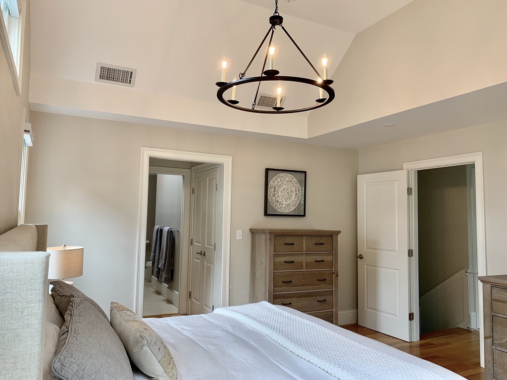 31 Bubier Road Marblehead, MA 01945 - Photo 14 of 29 a bedroom with a bed and a chandelier