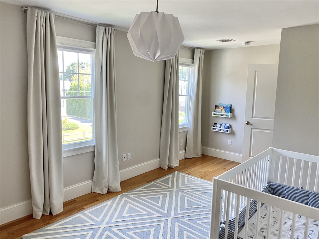 31 Bubier Road Marblehead, MA 01945 - Photo 18 of 29 a view of a bedroom with wooden floor and windows