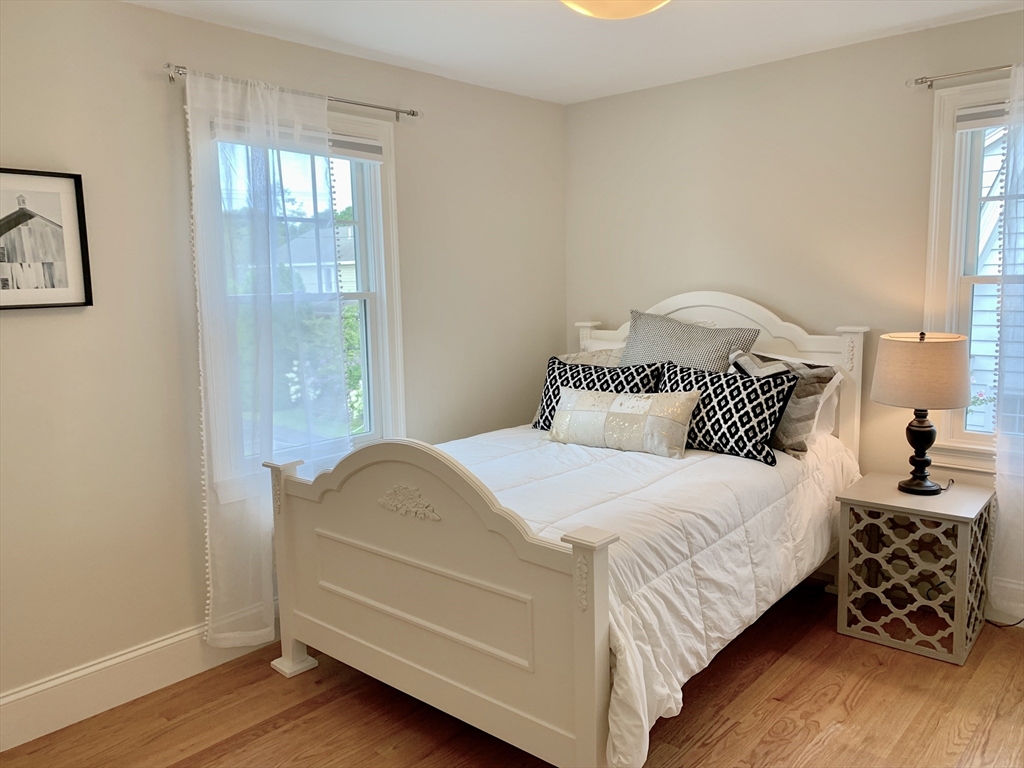 31 Bubier Road Marblehead, MA 01945 - Photo 21 of 29 a bedroom with a bed and wooden floor