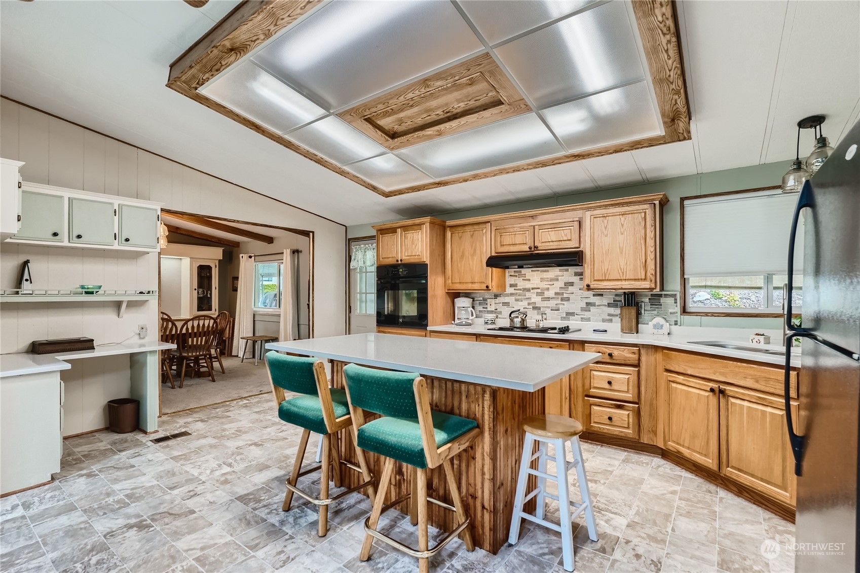 2500 South 370th Street, Unit 196 Federal Way, WA 98003 - Photo 12 of 29 a large kitchen with cabinets chairs and wooden floor